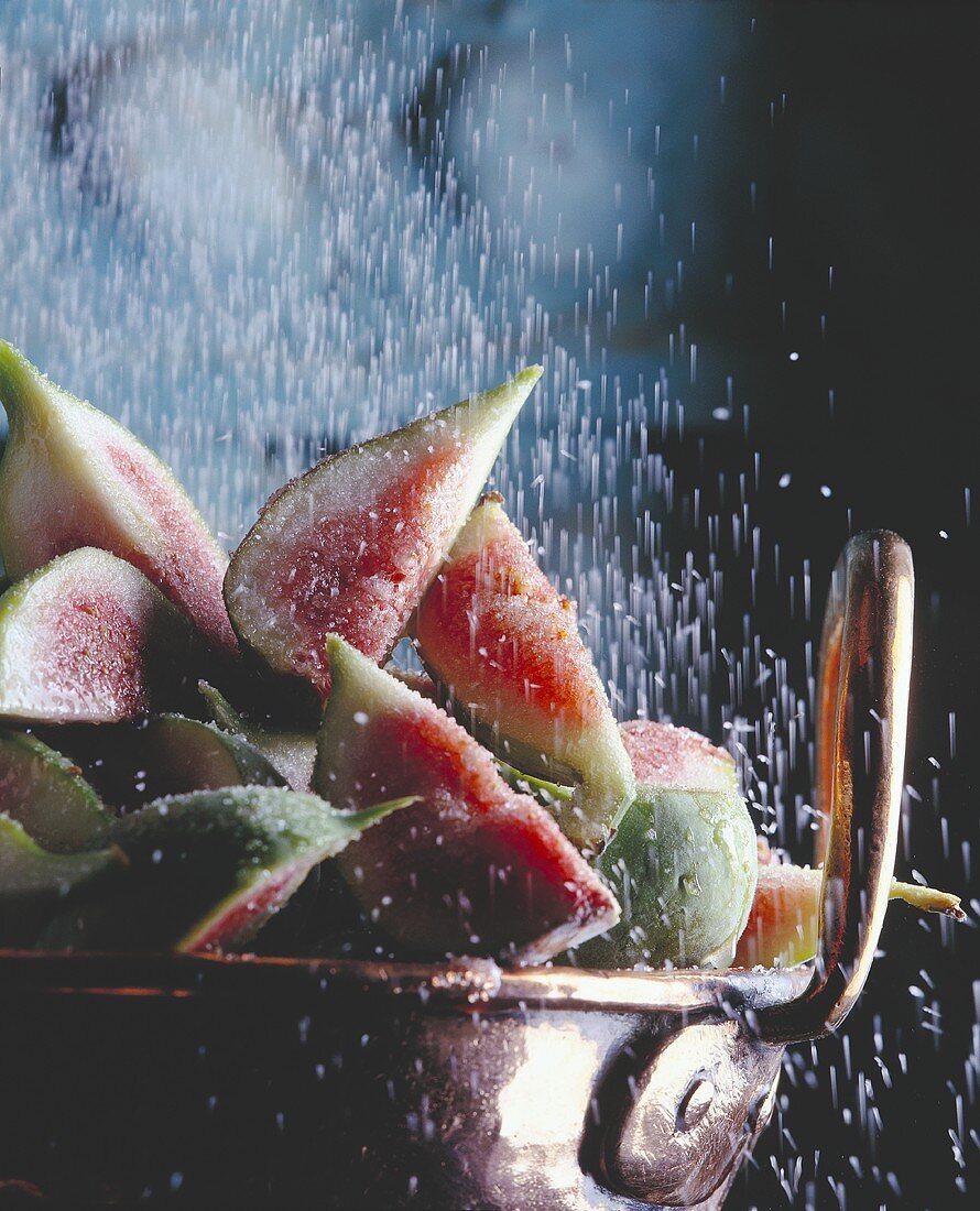 Sprinkling Sugar Over Sliced Figs