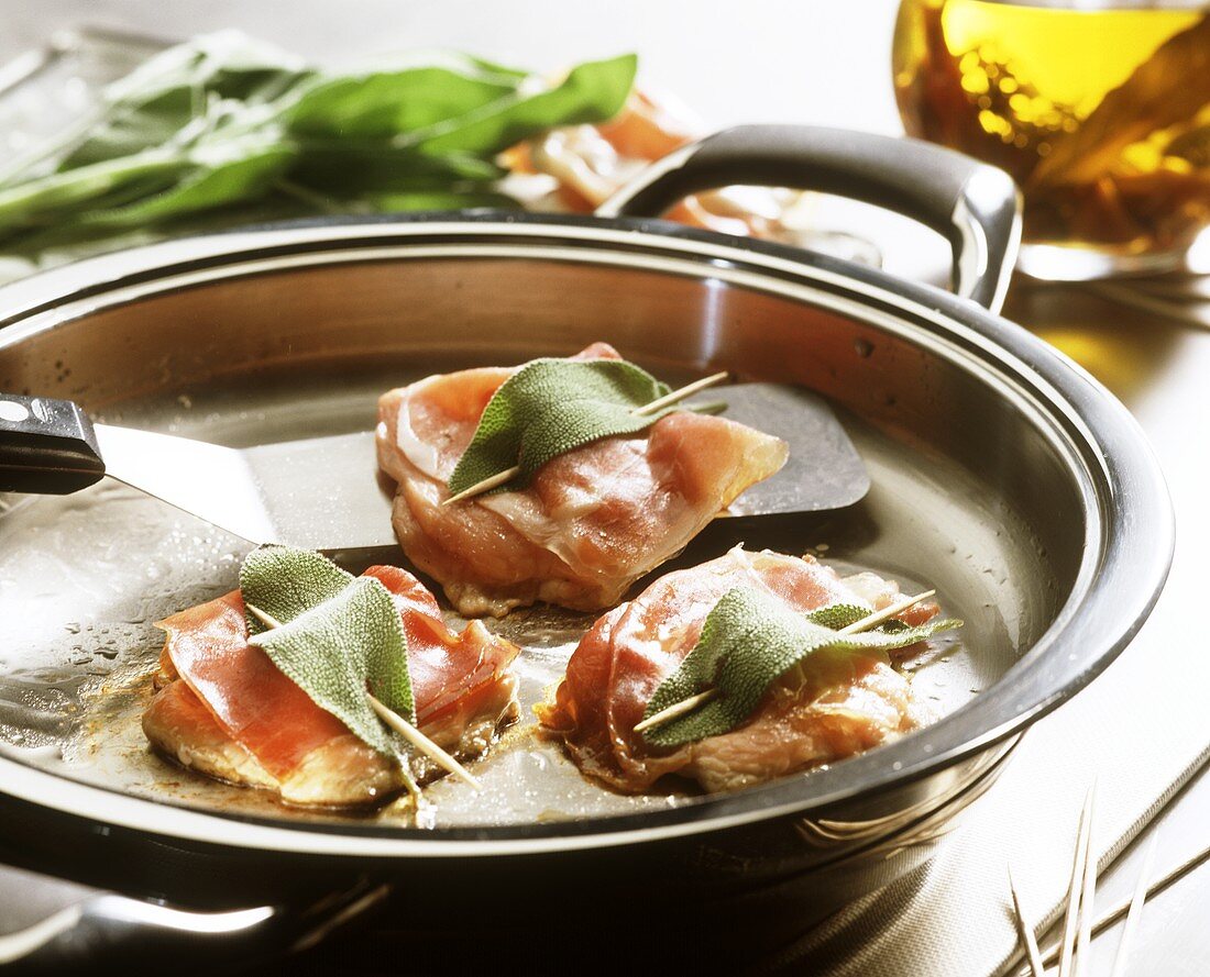 Frying veal escalope with sage (saltimbocca alla romana)