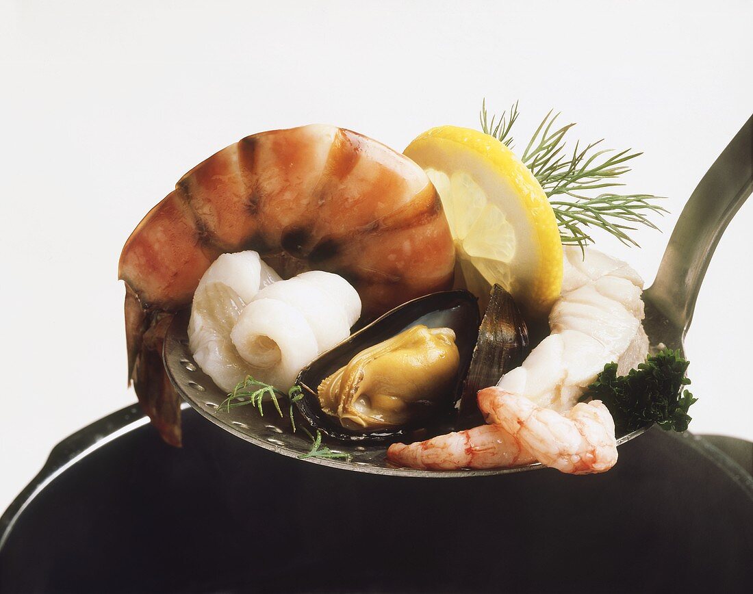Seafood with a slice of lemon on a skimmer