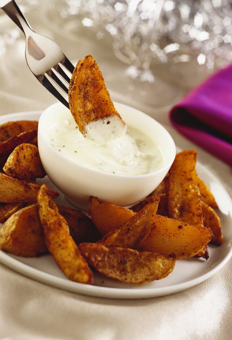 Fried potato pieces with sour cream dip