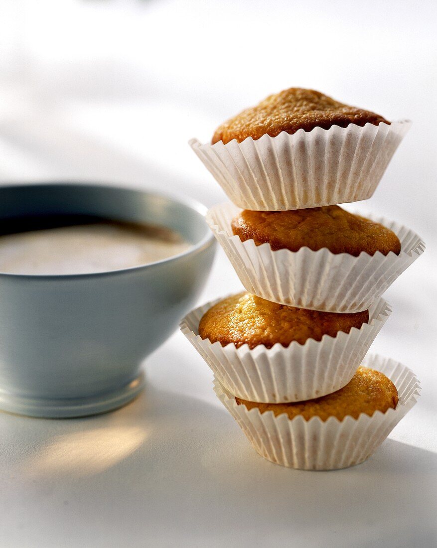 Four mini-muffins on top of each other, white coffee 