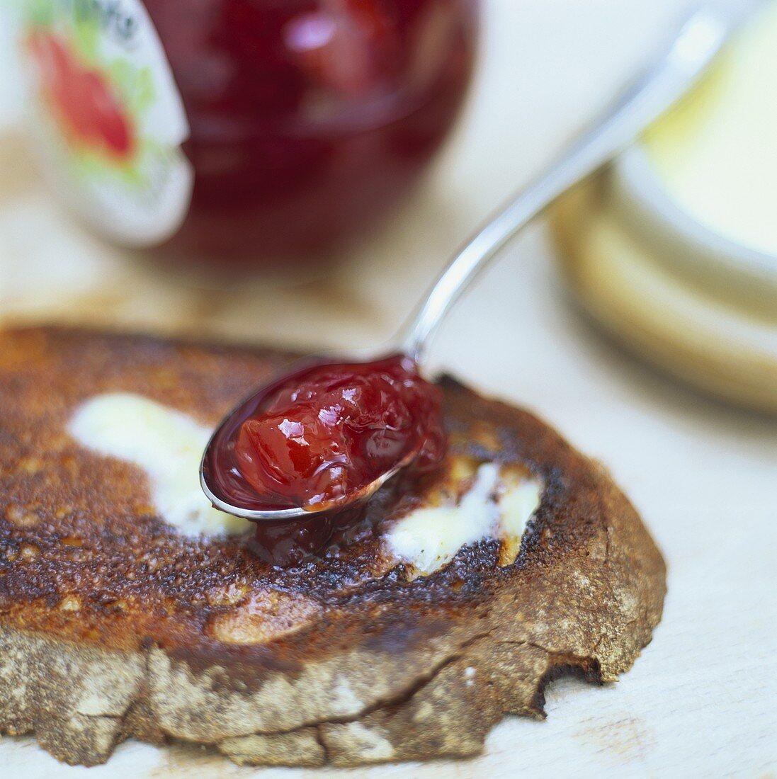 Toasted bread and a spoonful of cranberry jam