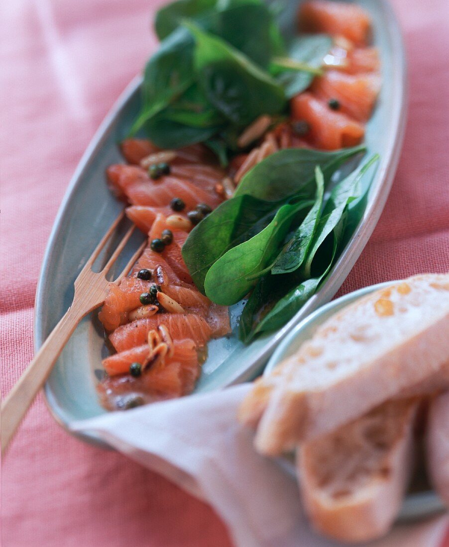 Marinated salmon with spinach salad