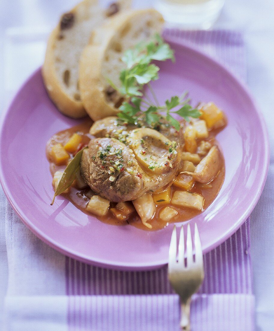 Ossobuco con la gremolata (Braised slices of veal shank)