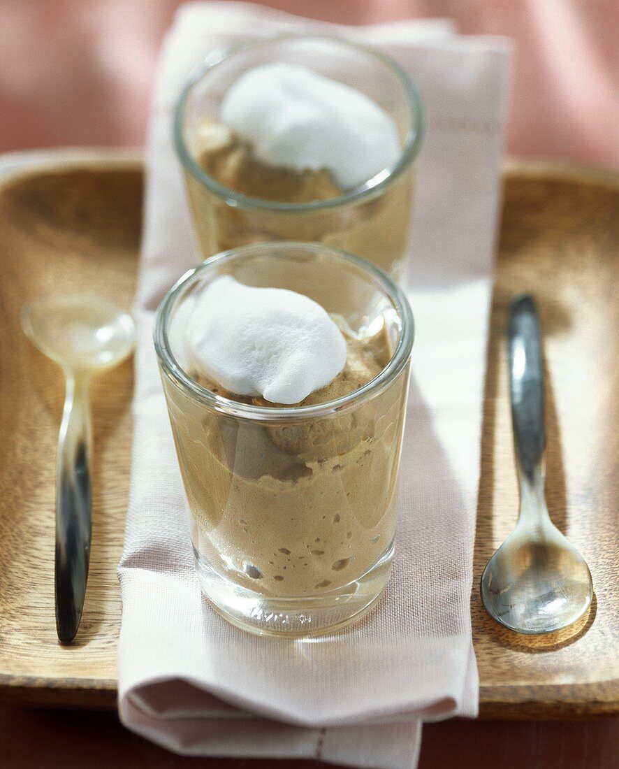 Cappuccino mousse with cream topping in glass