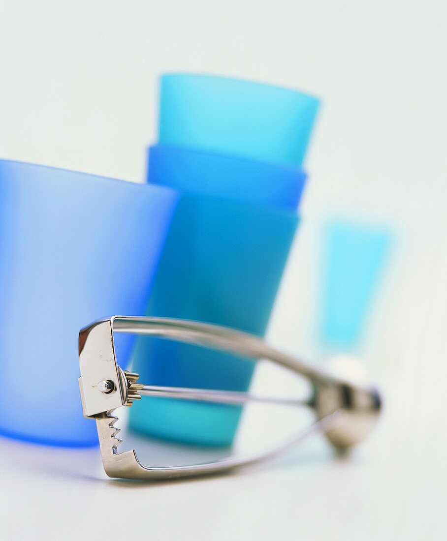 Blue mugs behind ice cream scoop