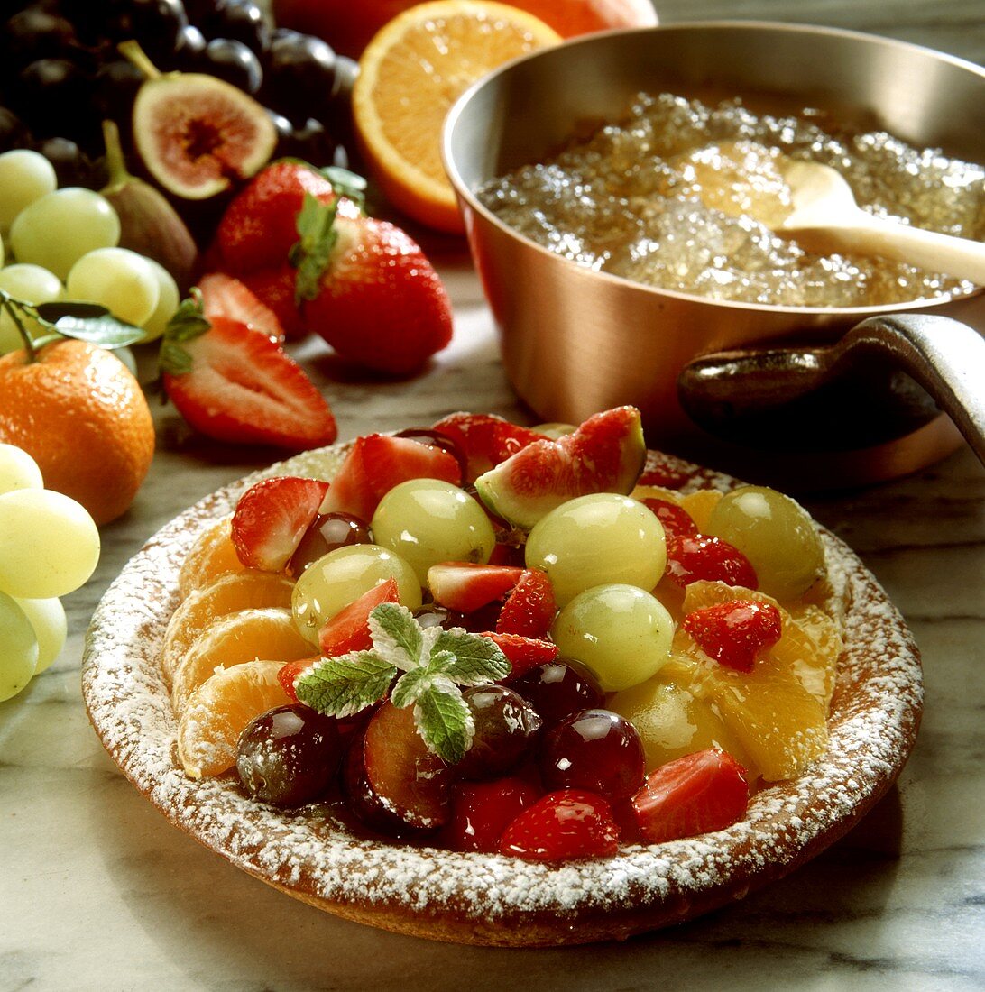 A fruit tart, pan with gelatine behind
