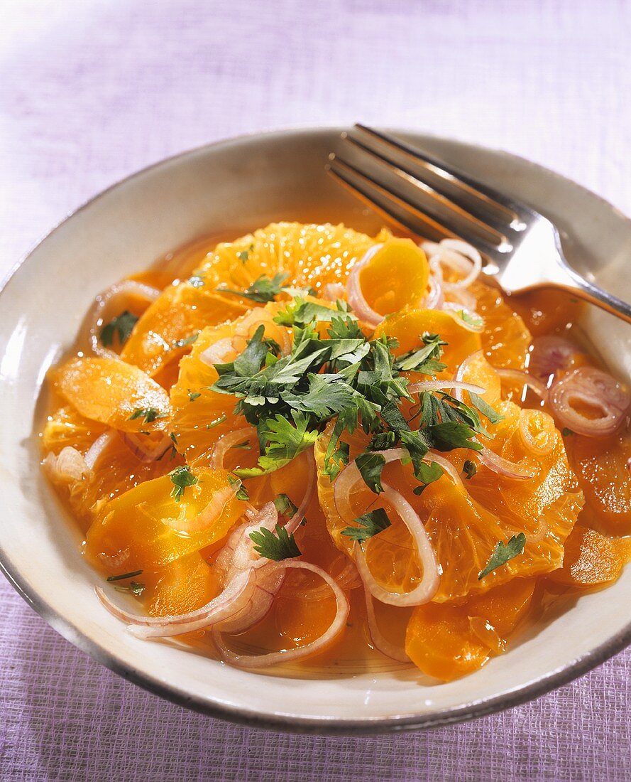 Carrot and orange salad with onions and coriander leaves