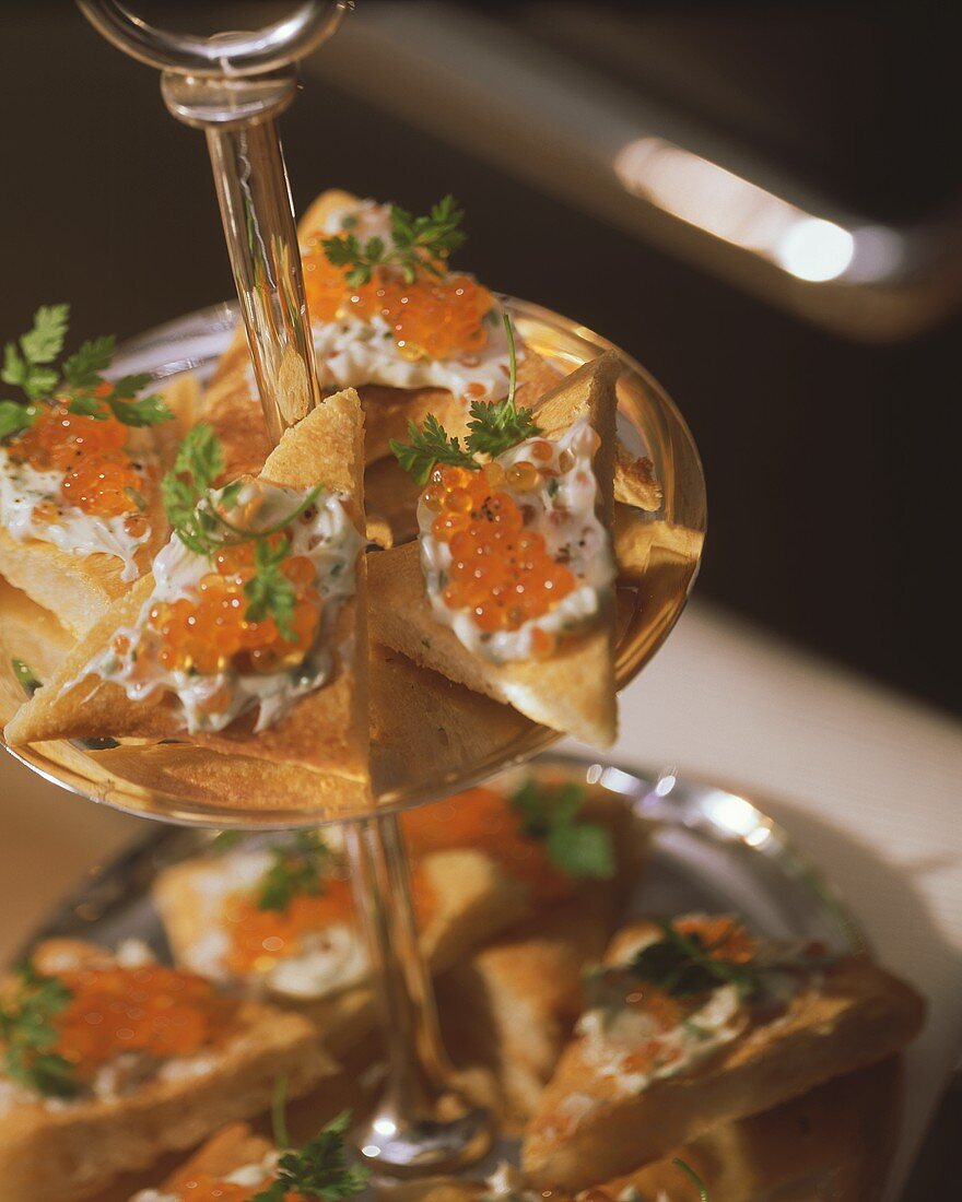 Canapés with caviar butter on tiered stand