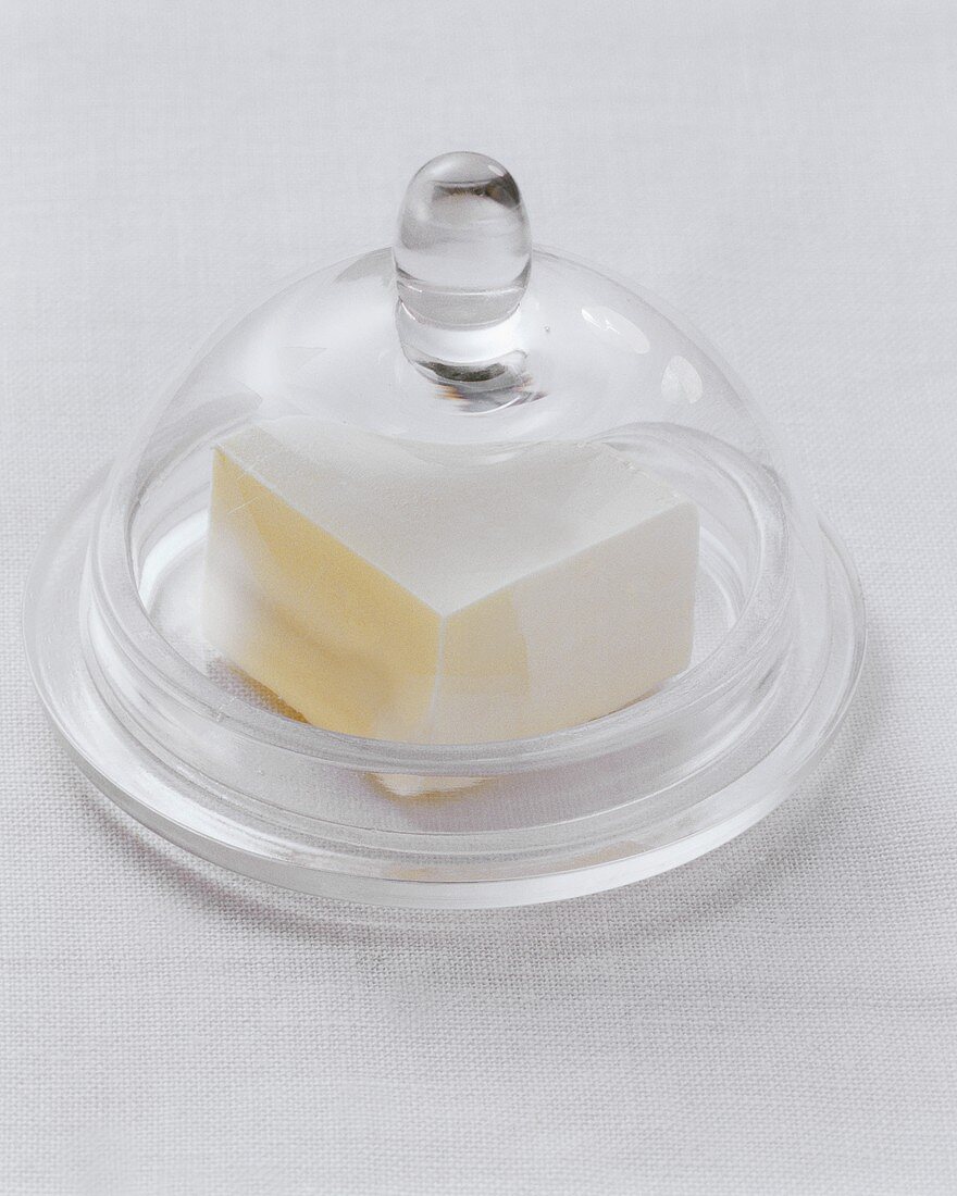 Piece of butter under cheese dome