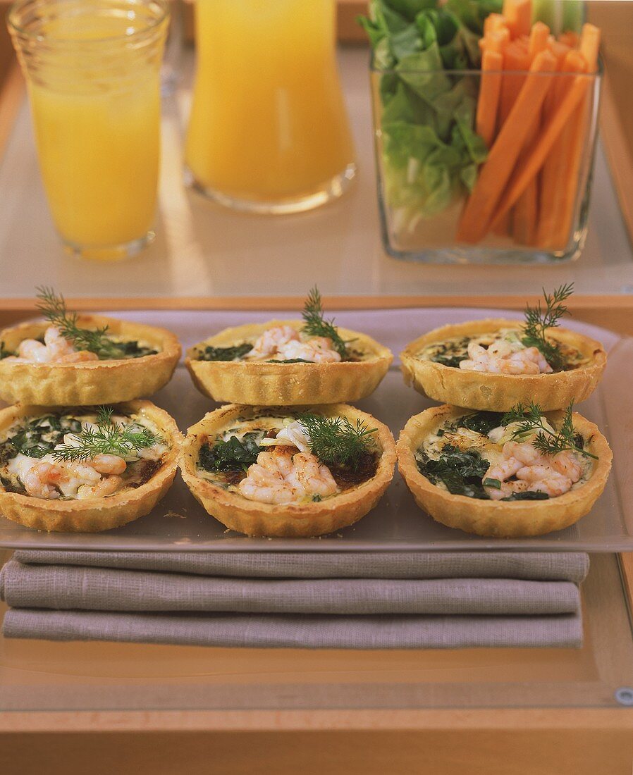 Shrimp quiches for fitness brunch; raw vegetables; fruit juice