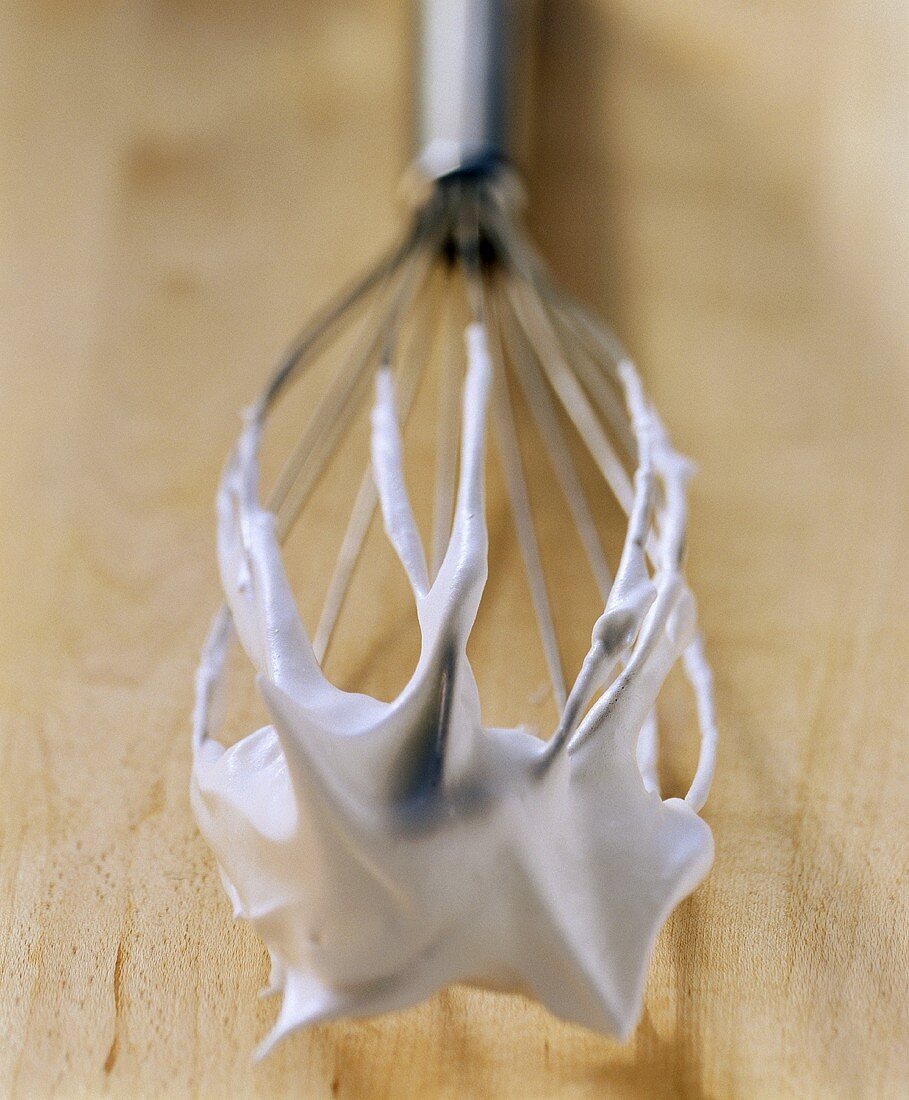 Whisk with scraps of beaten egg white