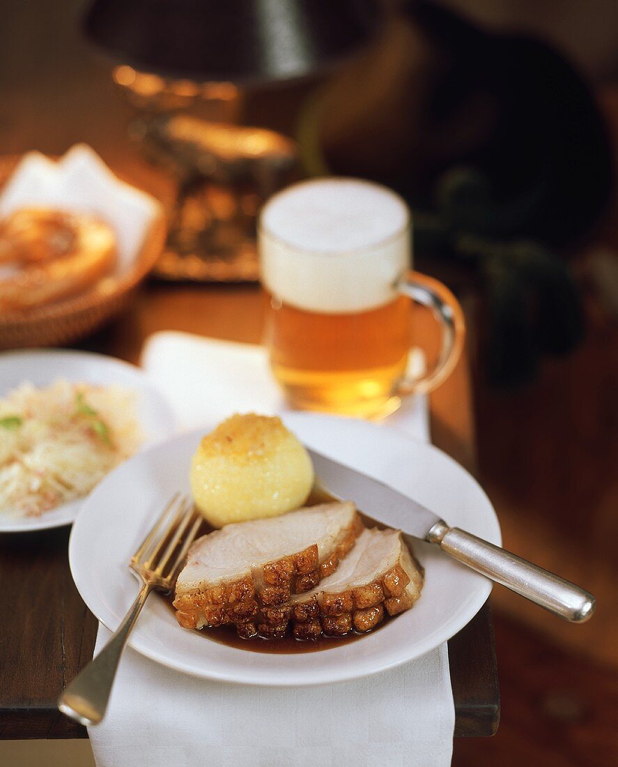 Roast pork with crackling, with potato dumpling; beer