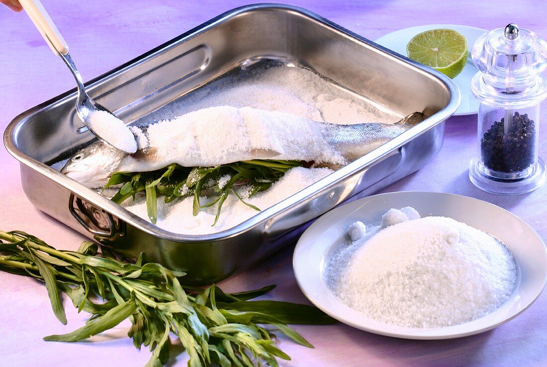 Preparing trout with tarragon stuffing and salt crust