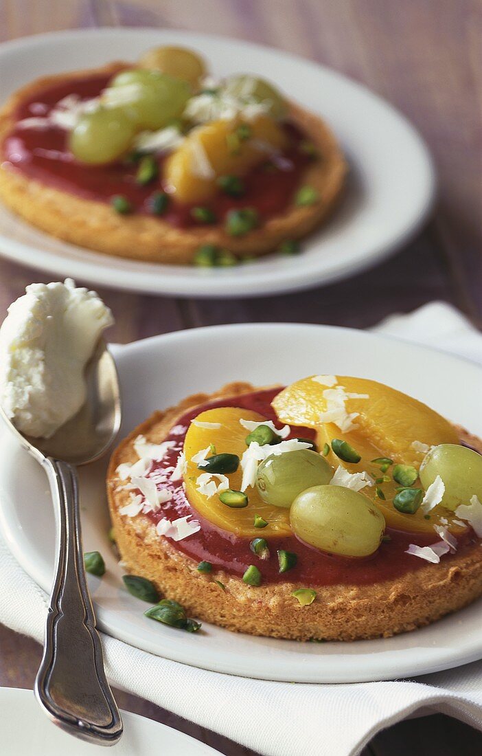 Fruit tarts with chopped pistachios & white chocolate curls
