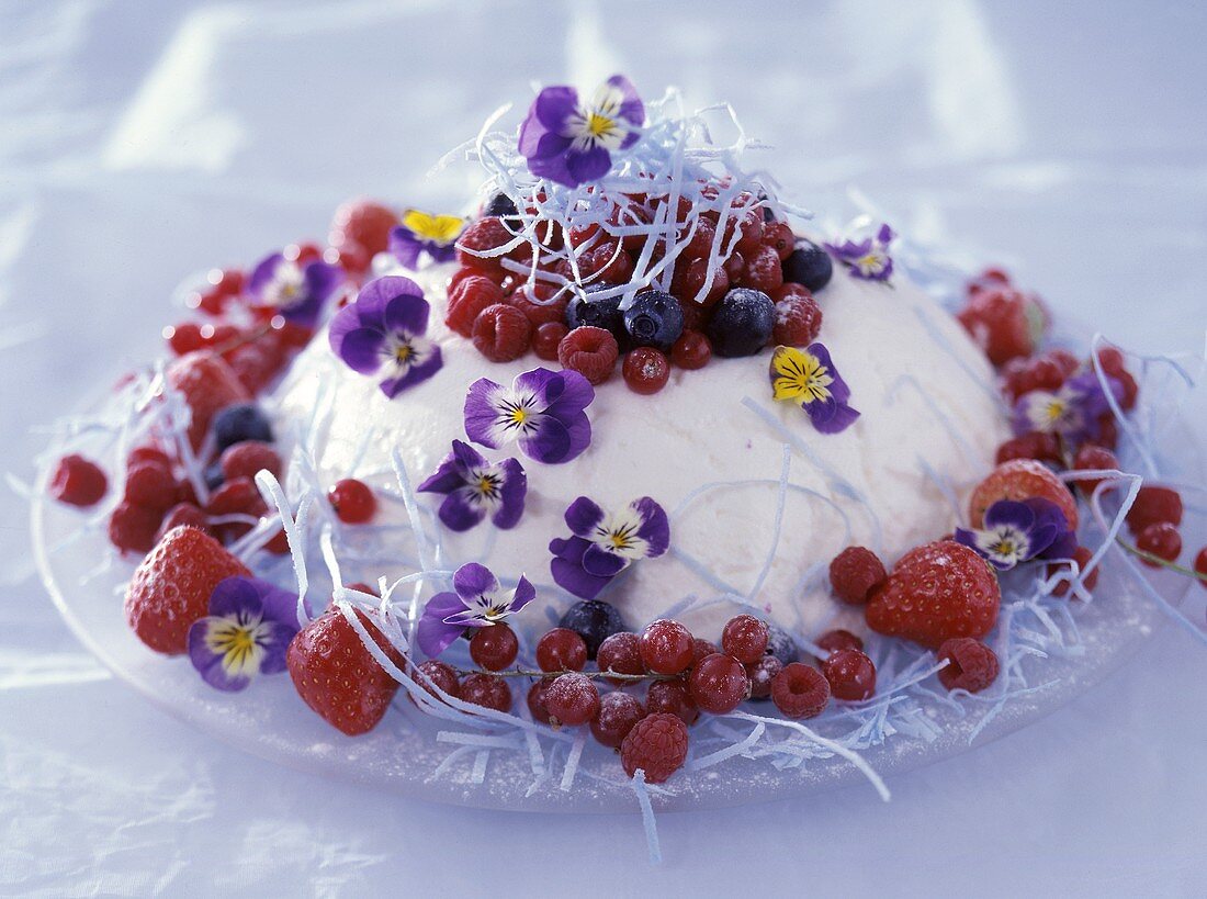 Mascarpone mousse with mixed berries and edible flowers