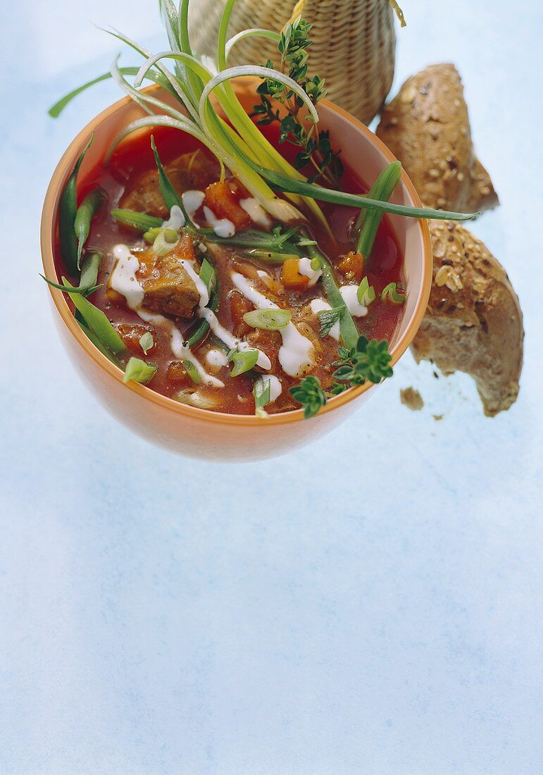 Fish soup with tomatoes, beans and sour cream