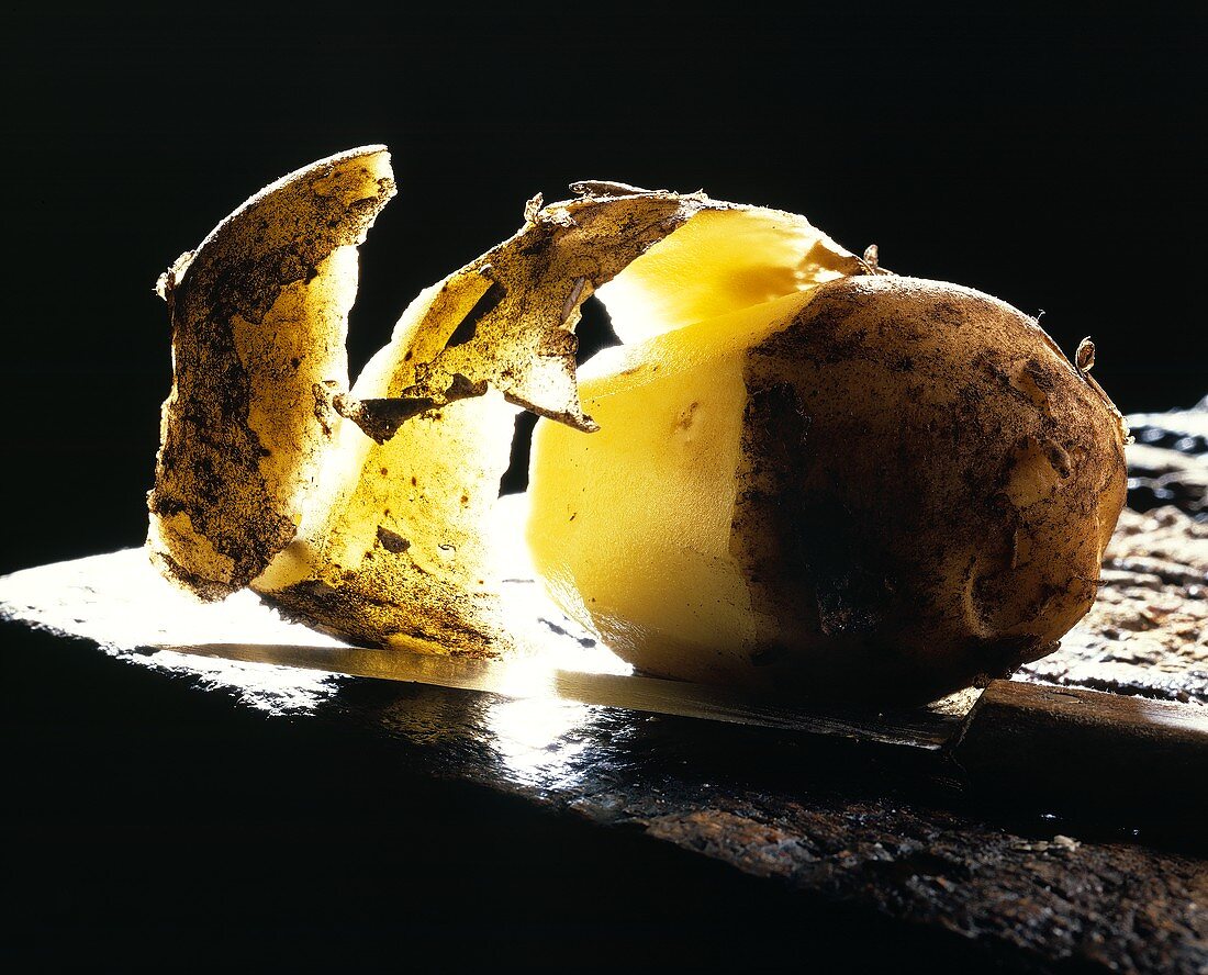 A half-peeled potato