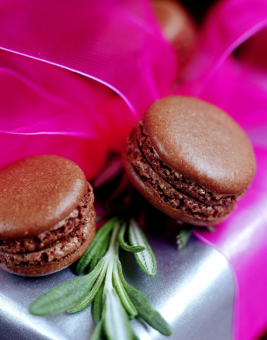 Filled chocolate macaroons on gift box