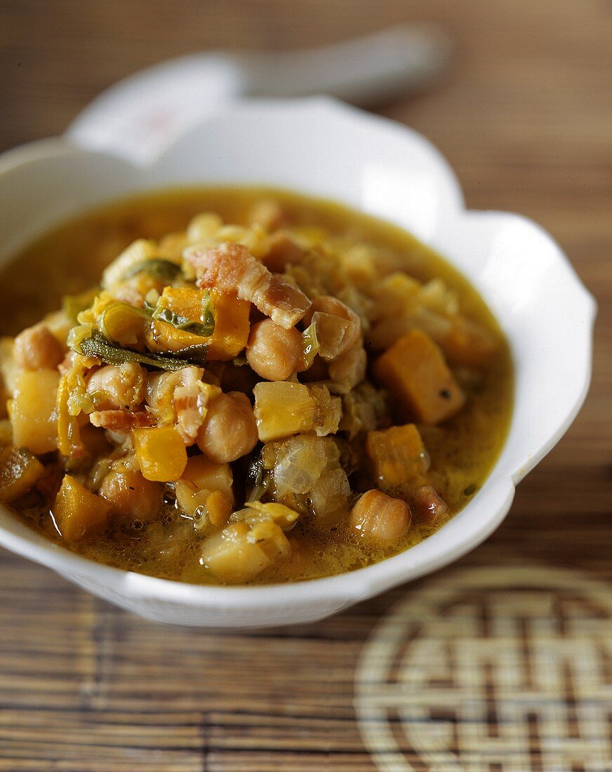 Pumpkin and chick pea stew with pieces of bacon