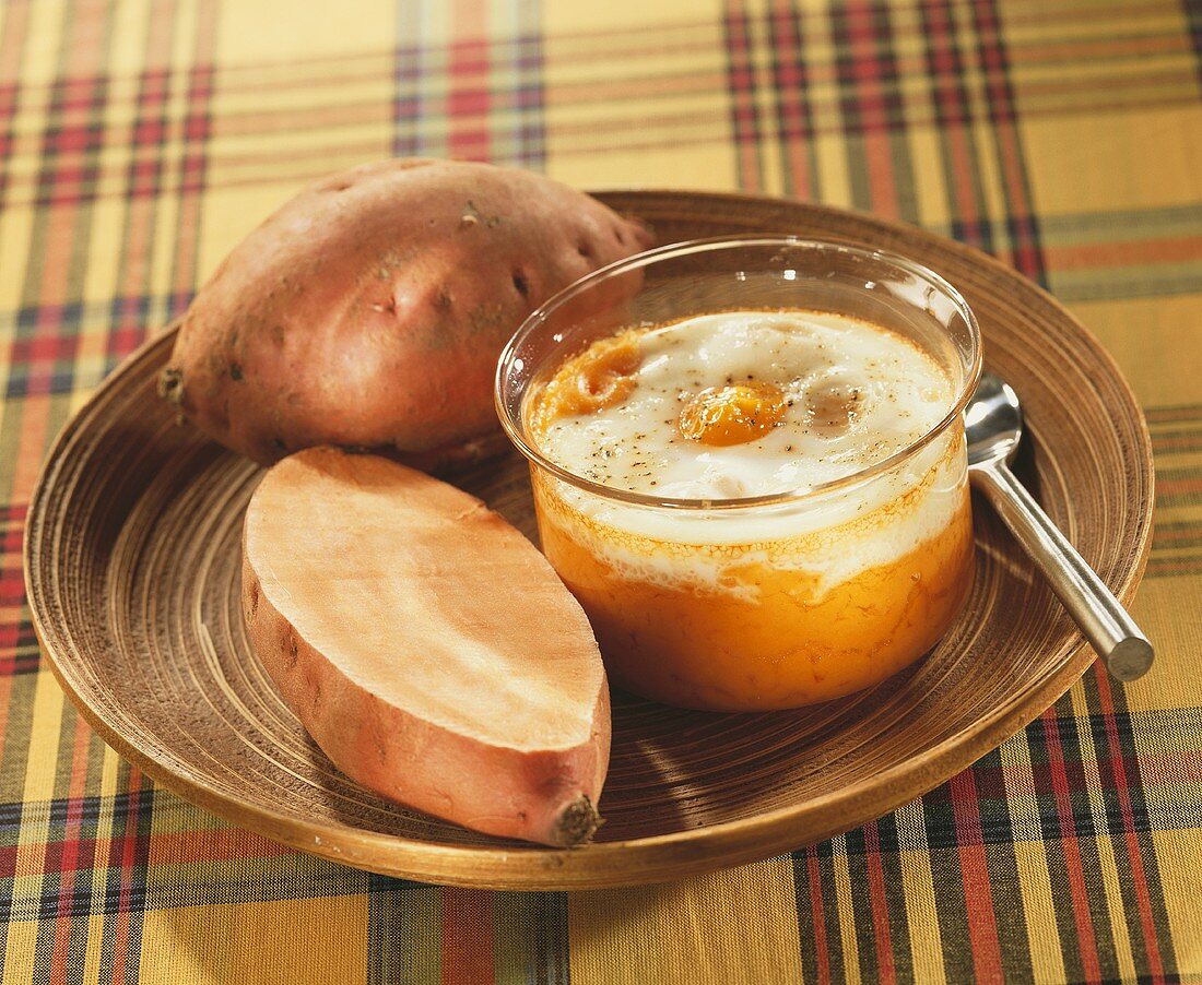 Fried eggs on mashed sweet potato in glass