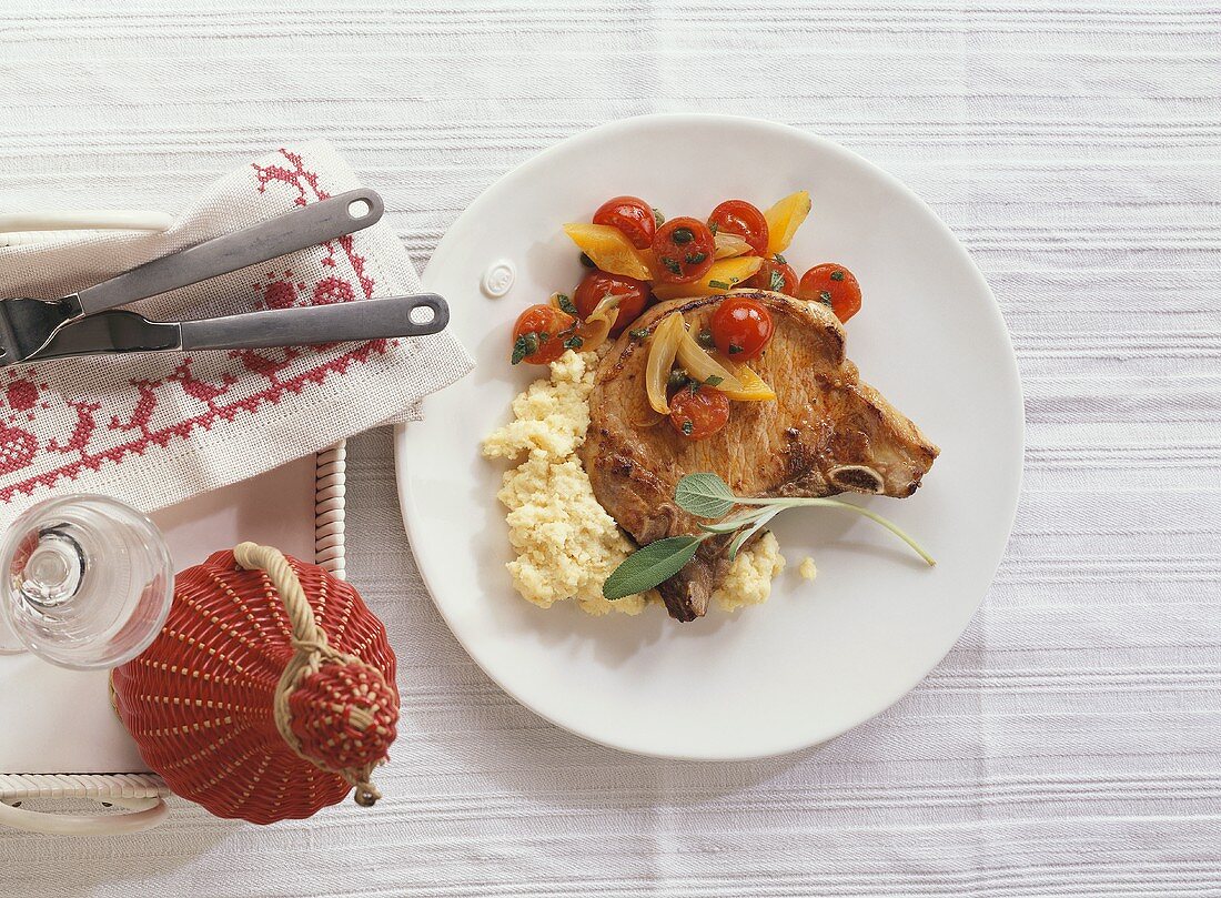 Pork chop with tomatoes and polenta