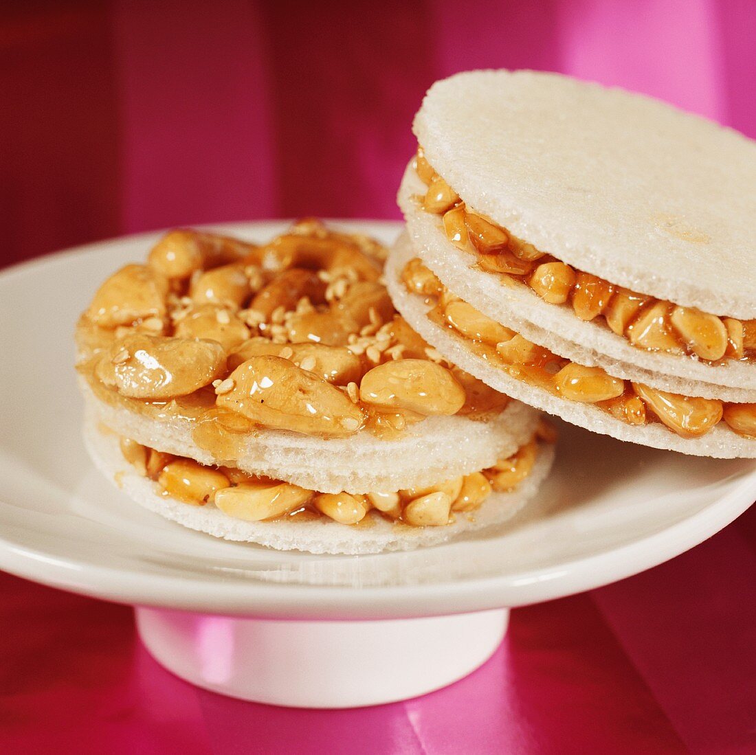 Two cashew cakes on cake plate