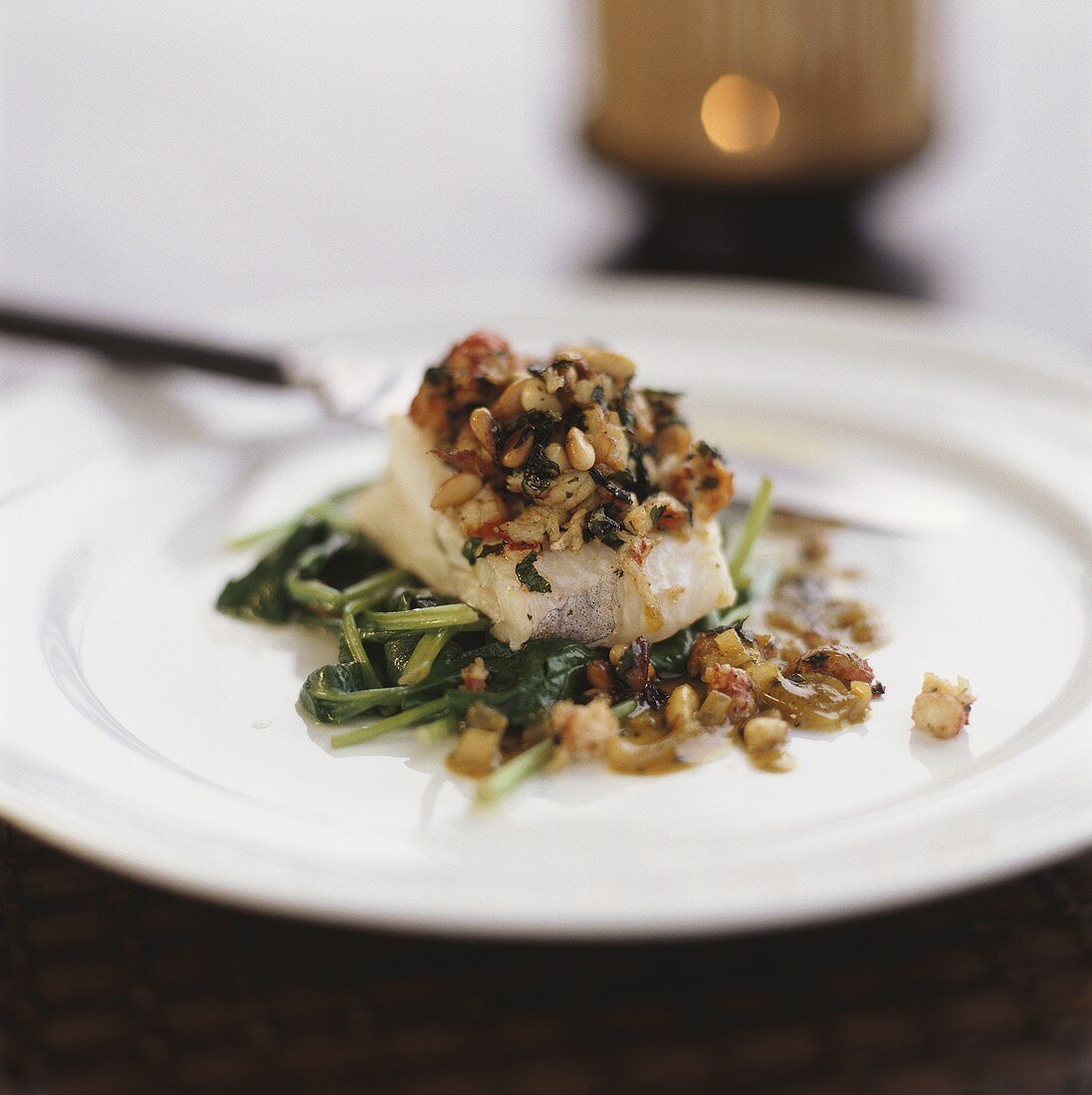 Oven-baked cod with spinach and pine nuts