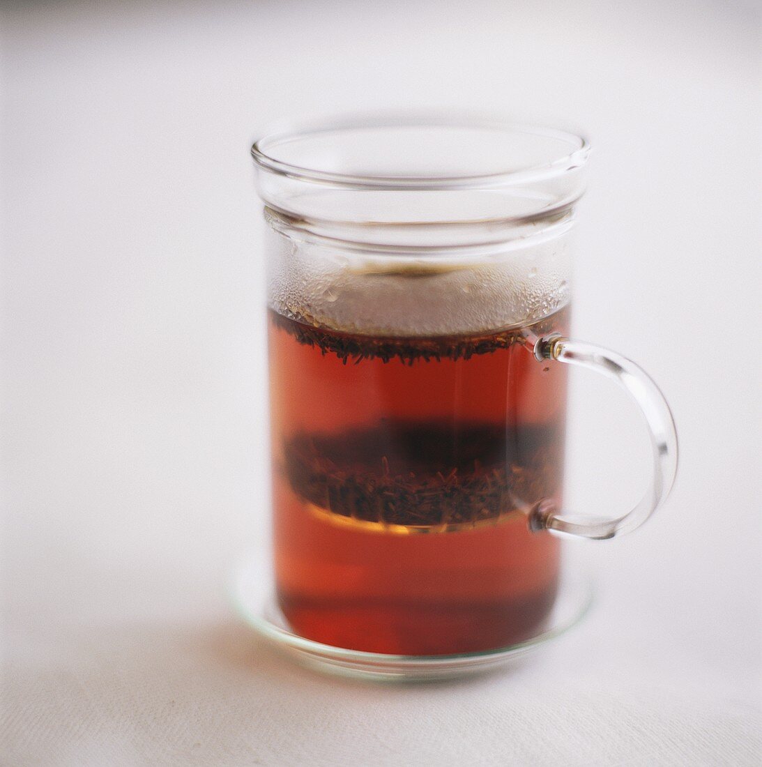 Tea with tea leaves in glass