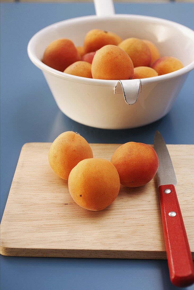 Apricots on chopping board and in strainer