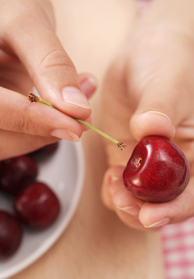 Removing cherry stalks