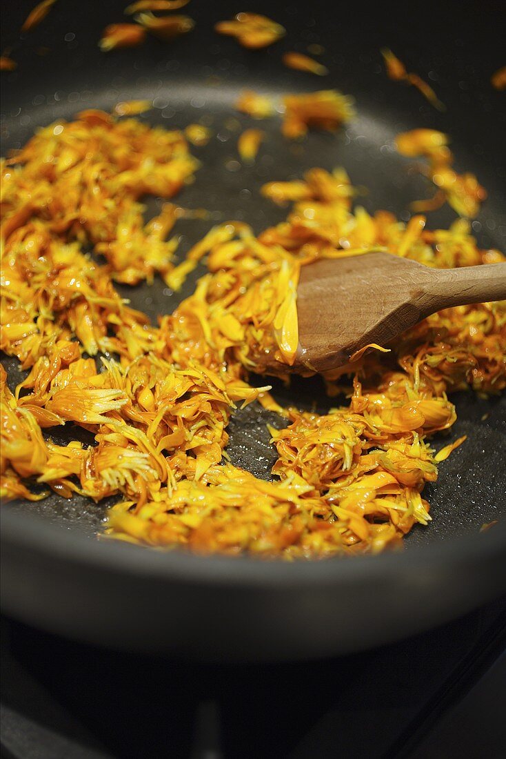 Frying marigolds in frying pan