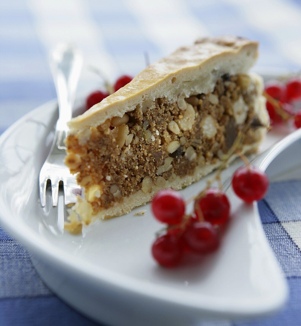 Piece of nut cake with redcurrants