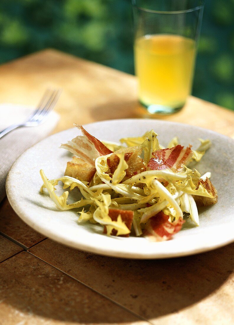 Dandelion salad with bacon and croutons