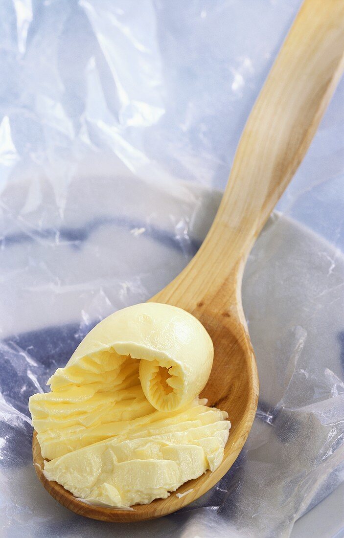 Margarine on wooden spoon