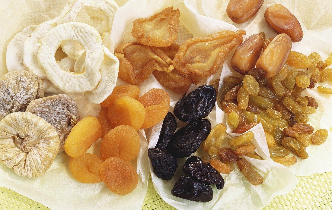 Various types of dried fruit on paper