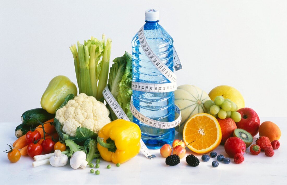 Vegetables, fruit, water & tape measuring (symbolising diet)