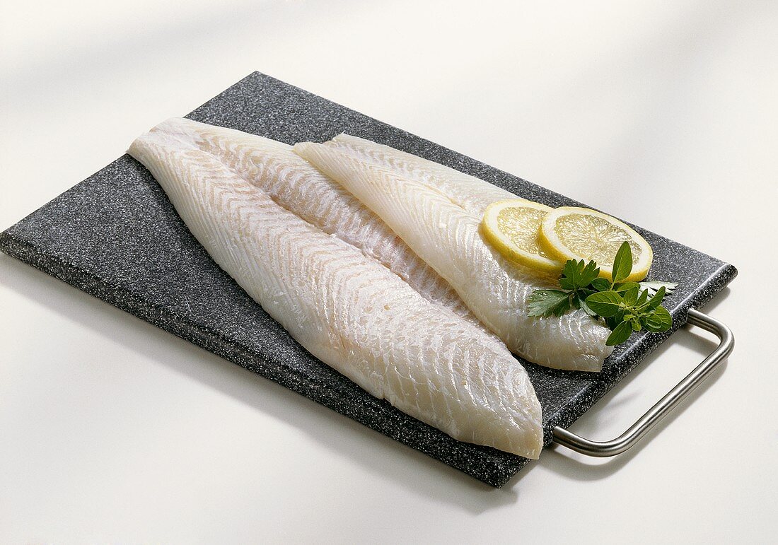 Halibut fillets on chopping board