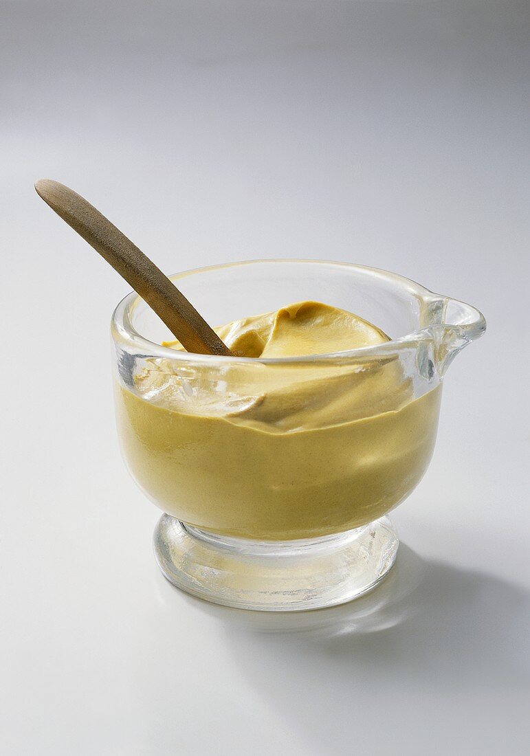 Mustard in jar with spoon