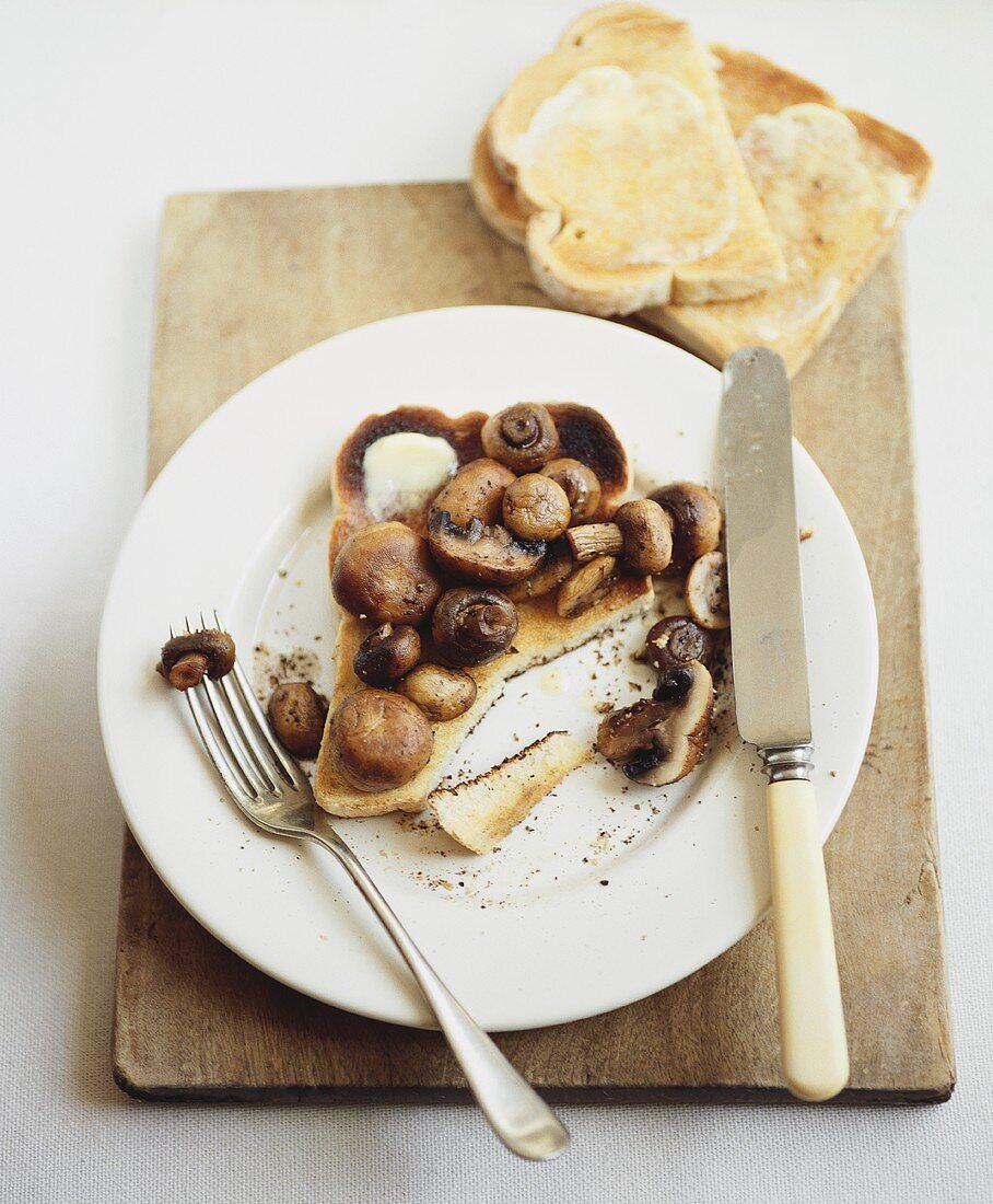 Toast with butter and fried mushrooms