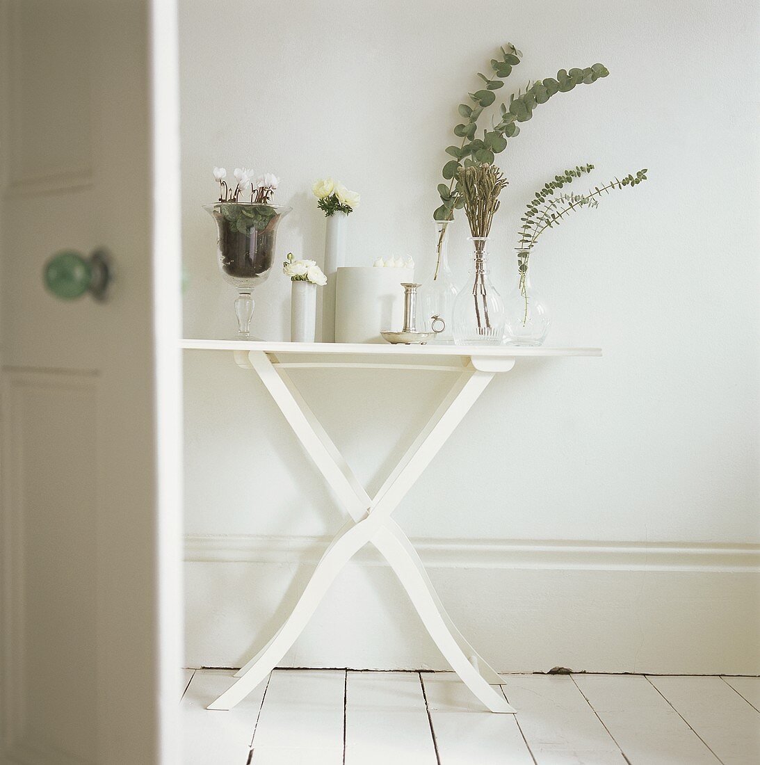 Side table decorated with flowers, greenery and candles