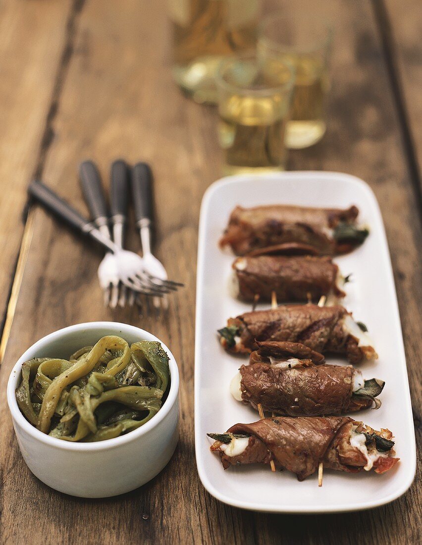 Veal rolls with sage, raw ham and bean salad