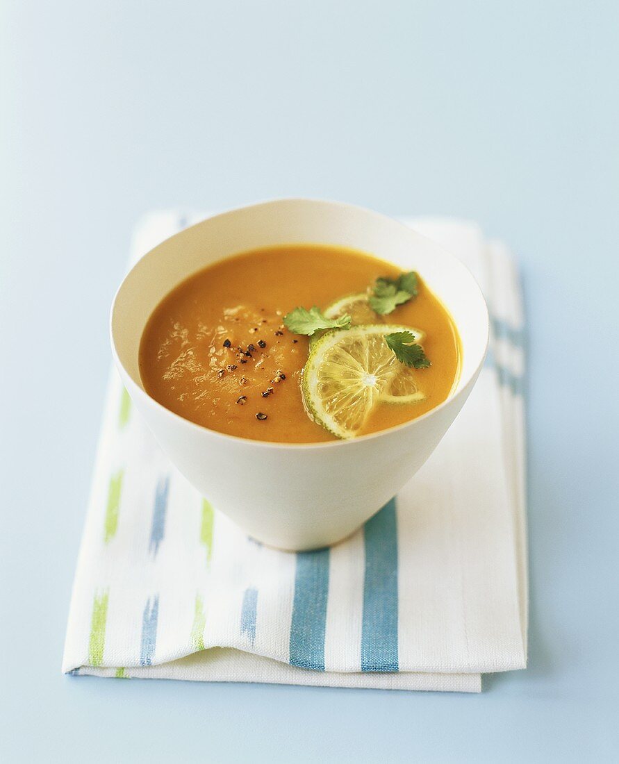 Pumpkin and coconut soup with lime and coriander leaves