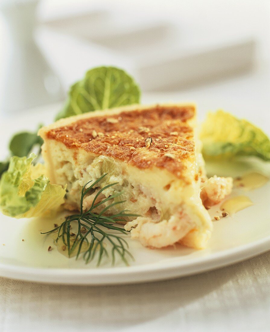 Piece of shrimp tart with salad garnish