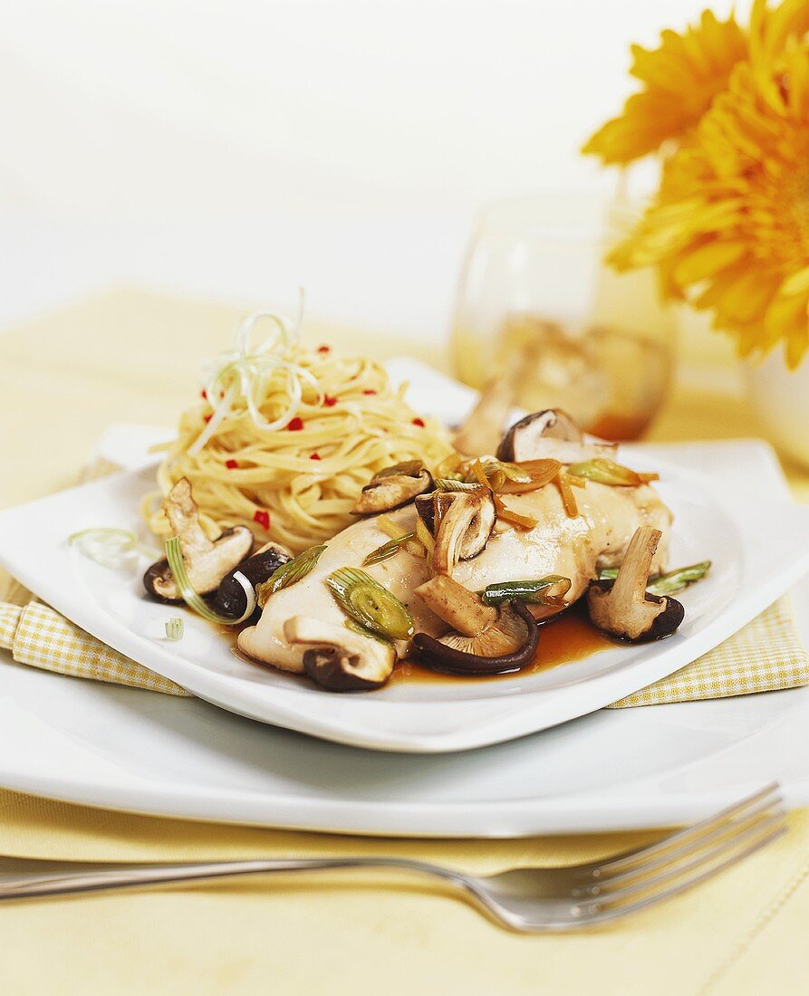 Poached chicken breast with mushrooms and linguine