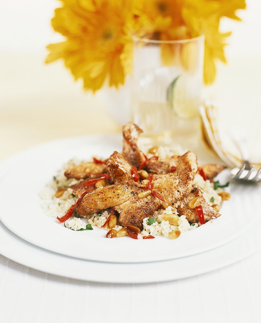 Pork with chili, pine nuts and couscous