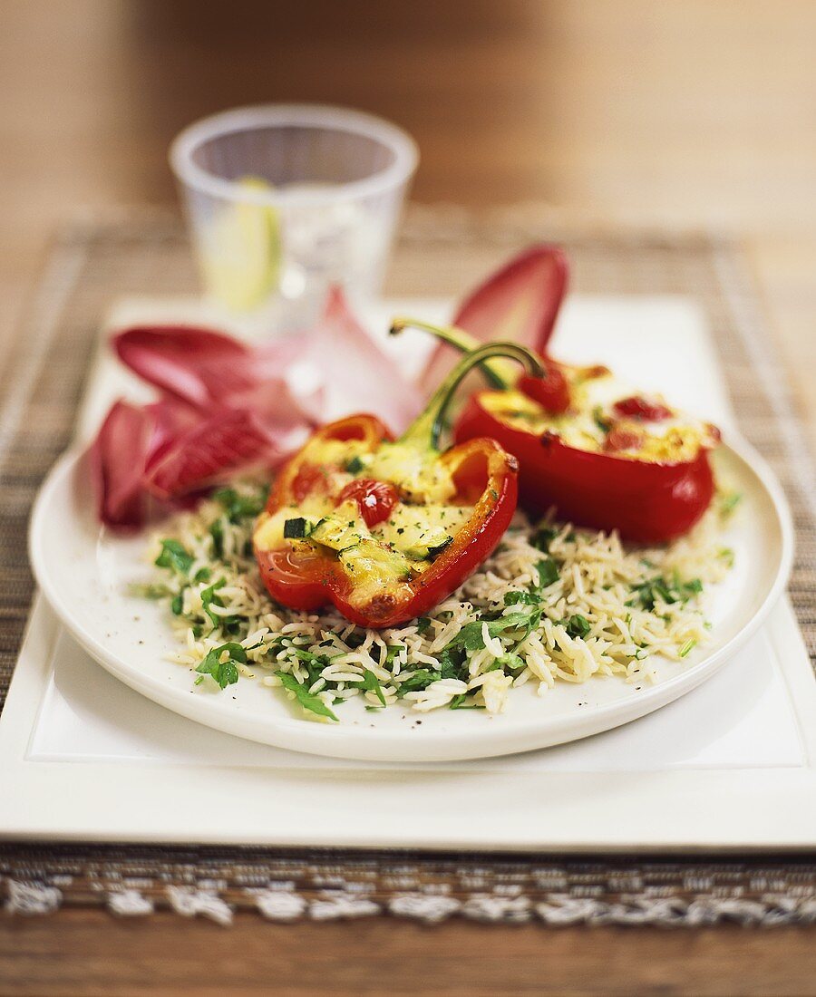 Stuffed red peppers on herb rice