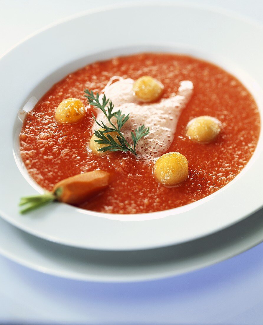 Cold, sweet carrot soup with glazed apple balls