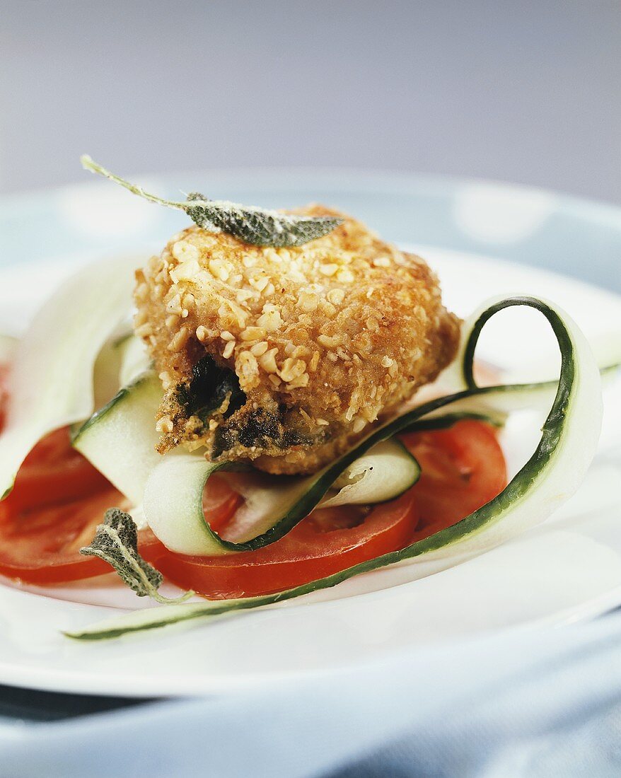 Stuffed pork medallions on tomatoes and courgettes