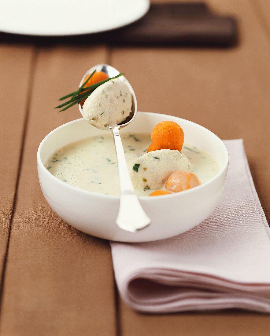 Herb soup with dumplings and carrots